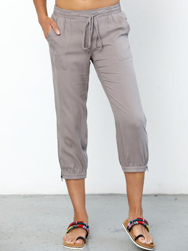 ICONIC go parachute capri pant - Machine washable pull on silk capri jogger with full back elastic waist with drawstring detail. It features metal hardware detail with front patch pockets and an elasticized zip-slit hem with snaps. 