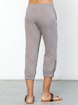 ICONIC go parachute capri pant - Machine washable pull on silk capri jogger with full back elastic waist with drawstring detail. It features metal hardware detail with front patch pockets and an elasticized zip-slit hem with snaps. 