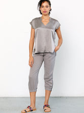 Load image into Gallery viewer, ICONIC go parachute capri pant - Machine washable pull on silk capri jogger with full back elastic waist with drawstring detail. It features metal hardware detail with front patch pockets and an elasticized zip-slit hem with snaps. 