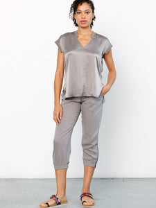 ICONIC go parachute capri pant - Machine washable pull on silk capri jogger with full back elastic waist with drawstring detail. It features metal hardware detail with front patch pockets and an elasticized zip-slit hem with snaps. 