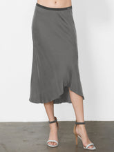 Load image into Gallery viewer, ICONIC go luxe bias skirt - Machine washable silk charmeuse midi length skirt that has a bias cut and asymmetrical seamed hem and a velvet elastic waistband. 