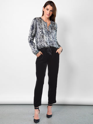 Go velvet everyday pants - Hand wash or dry cleanable 82% rayon and 18% silk velvet pull on mixed pants with silk drawstring cord at waist with self tassel. It has an elastic waistband that sits just below the natural waist with a 9 inch rise. It has front slit pockets with a tapered leg and cuffed hems, its at a 25 inch inseam based on a size small. 