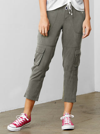 ICONIC go utility pant - Machine washable silk and spandex blend pants with banded waist that sits just below the natural waist at a 9.5 inch rise on a size 4. It has a zip fly snap closure with multiple pocket detailing and burnished hardware trim and cropped skinny-leg fit. It has a zip-slit hem and a 26 inch inseam length based on a size 4. 