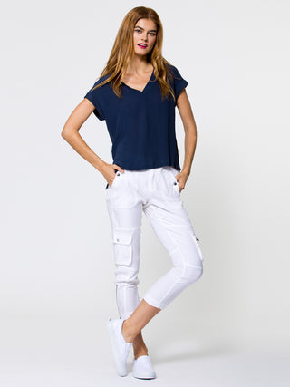 ICONIC go utility pant - Machine washable silk and spandex blend pants with banded waist that sits just below the natural waist at a 9.5 inch rise on a size 4. It has a zip fly snap closure with multiple pocket detailing and burnished hardware trim and cropped skinny-leg fit. It has a zip-slit hem and a 26 inch inseam length based on a size 4. 